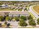 Aerial view of a neighborhood showcasing well-maintained townhomes and mature trees at 15580 Blackbead St, Winter Garden, FL 34787