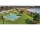 Aerial view of a basketball court near a lake and playground in a residential area at 15580 Blackbead St, Winter Garden, FL 34787