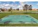 Outdoor basketball court on a sunny day surrounded by lush green grass and neighborhood homes at 15580 Blackbead St, Winter Garden, FL 34787