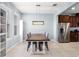 Cozy dining area with modern light fixture and adjacent to kitchen at 15580 Blackbead St, Winter Garden, FL 34787