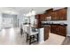 Open-concept kitchen with island seating, stainless steel appliances, and tile floors at 15580 Blackbead St, Winter Garden, FL 34787