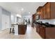 Updated kitchen featuring a large island, stainless appliances, and tile flooring at 15580 Blackbead St, Winter Garden, FL 34787