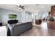 Open-concept living room showcases a modern design with seamless transition to the kitchen and dining area at 15580 Blackbead St, Winter Garden, FL 34787