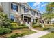 A row of townhouses with well-maintained lawns and beautiful landscaping at 15580 Blackbead St, Winter Garden, FL 34787