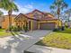 Beautiful two-story home featuring a red tile roof and a two-car garage at 161 Orange Cosmos Blvd, Davenport, FL 33837