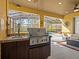 Outdoor kitchen featuring a built-in grill and sink, adjacent to a covered patio with pool view at 161 Orange Cosmos Blvd, Davenport, FL 33837