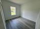 Bright bedroom features light gray floors, white walls and a large window providing natural light at 16947 Sw 22Nd Terrace Rd, Ocala, FL 34473
