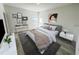 Bright bedroom featuring a stylish bed, side tables, a writing desk, and artistic wall decorations at 16947 Sw 22Nd Terrace Rd, Ocala, FL 34473