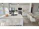 Bright kitchen with white cabinets, stainless steel appliances, quartz countertops, and an island at 16947 Sw 22Nd Terrace Rd, Ocala, FL 34473