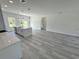 Bright, open-concept living room features an island and light gray flooring with windows at 16947 Sw 22Nd Terrace Rd, Ocala, FL 34473
