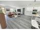 Spacious open-concept living and kitchen area with modern décor and beautiful wood-look floors at 16947 Sw 22Nd Terrace Rd, Ocala, FL 34473