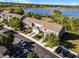 Aerial view of townhomes showcasing lakeside community with lush landscaping at 1968 Compass Flower Way, Ocoee, FL 34761