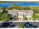 Aerial view of townhomes near lake, featuring lush landscaping and convenient parking at 1968 Compass Flower Way, Ocoee, FL 34761