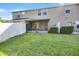 Spacious backyard features lush green grass, screened-in patio, and privacy fence at 1968 Compass Flower Way, Ocoee, FL 34761