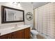 Bathroom featuring a vanity with a large mirror, modern shelving, and a shower with a patterned curtain at 1968 Compass Flower Way, Ocoee, FL 34761