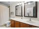 Well lit bathroom featuring double mirrors, a white countertop, and updated fixtures and vanity at 1968 Compass Flower Way, Ocoee, FL 34761