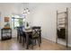 Cozy dining area with stylish lighting, seating for six, and a view of the backyard at 1968 Compass Flower Way, Ocoee, FL 34761