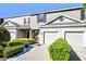 Charming townhome with manicured landscaping and attached garage, offering curb appeal at 1968 Compass Flower Way, Ocoee, FL 34761