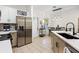 Bright kitchen featuring stainless steel refrigerator, modern countertops, and an adjacent dining area at 1968 Compass Flower Way, Ocoee, FL 34761