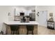 Bright kitchen featuring stainless steel appliances, a modern faucet, and a stylish countertop with barstool seating at 1968 Compass Flower Way, Ocoee, FL 34761