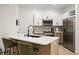Well-lit kitchen features modern appliances, a spacious countertop island with barstool seating, and stylish backsplash at 1968 Compass Flower Way, Ocoee, FL 34761