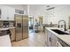Bright kitchen featuring stainless steel refrigerator, modern countertops, and an adjacent dining area at 1968 Compass Flower Way, Ocoee, FL 34761