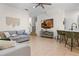 Open-concept living room with TV, seating, and bar area, creating an inviting atmosphere at 1968 Compass Flower Way, Ocoee, FL 34761