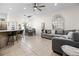 Bright, open-concept living room featuring bar seating and dining area adjacent to a comfortable living space at 1968 Compass Flower Way, Ocoee, FL 34761