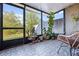 Enclosed patio with patterned tile, large windows, comfortable seating, and garden creating a relaxing retreat at 1968 Compass Flower Way, Ocoee, FL 34761