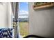 Scenic view from a Bedroom window overlooking a green landscape and blue lake under a bright sky at 1968 Compass Flower Way, Ocoee, FL 34761