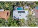 Stunning aerial view of home featuring a screened-in pool, solar panels, and outdoor fire pit seating at 204 Smokerise Blvd, Longwood, FL 32779