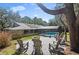 Spacious backyard featuring an outdoor firepit with chairs and a large shade tree at 204 Smokerise Blvd, Longwood, FL 32779