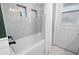 Bathroom with shower featuring tiled walls, built-in niche, and contrasting fixtures at 204 Smokerise Blvd, Longwood, FL 32779