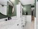 Bathroom with dual vanities, round mirrors, updated fixtures, and built-in shelving at 204 Smokerise Blvd, Longwood, FL 32779