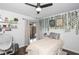 Well-lit bedroom with white furniture, vinyl floors and a sliding glass door to a patio at 204 Smokerise Blvd, Longwood, FL 32779