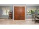 Elegant entryway with tiled floors, double wood doors, and large windows overlooking a lush garden at 204 Smokerise Blvd, Longwood, FL 32779