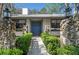 Inviting front entrance with stone accents, a blue double door, and manicured hedges at 204 Smokerise Blvd, Longwood, FL 32779