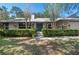 Charming home with a stone accent and double front doors with mature landscaping at 204 Smokerise Blvd, Longwood, FL 32779
