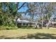 Well-maintained home with a green lawn, mature trees, and established landscaping in a peaceful neighborhood at 204 Smokerise Blvd, Longwood, FL 32779