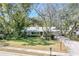 Charming single-story home with a well-manicured lawn and mature trees providing shade at 204 Smokerise Blvd, Longwood, FL 32779