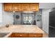 Kitchen island with granite countertop and stainless steel fridge next to an eat-in table at 204 Smokerise Blvd, Longwood, FL 32779