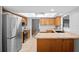 Spacious kitchen featuring stainless steel appliances, wooden cabinets, and ample counter space at 204 Smokerise Blvd, Longwood, FL 32779