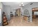Open-concept living room showcasing a unique stone fireplace, tiled floors, and lots of natural light at 204 Smokerise Blvd, Longwood, FL 32779