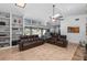 Spacious living room featuring tile floors, a built-in bookcase, and a view of the backyard pool at 204 Smokerise Blvd, Longwood, FL 32779