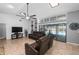 Bright living room with a TV, tile flooring, built-in shelving, and access to the backyard pool at 204 Smokerise Blvd, Longwood, FL 32779
