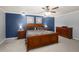 Main bedroom with wood furniture, a ceiling fan and blue accent wall at 204 Smokerise Blvd, Longwood, FL 32779