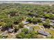 Picturesque aerial view of a property surrounded by lush greenery, and a neighborhood lake in the distance at 2058 Washington Ave, Sanford, FL 32771