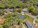 Aerial view showcasing a house and backyard nestled among a green, wooded neighborhood at 2058 Washington Ave, Sanford, FL 32771