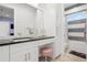 Elegant bathroom featuring a vanity with a dark countertop, a built-in seat, and stylish fixtures at 2058 Washington Ave, Sanford, FL 32771