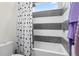Bathroom with a tub shower combo featuring black and white tiling and a decorative shower curtain at 2058 Washington Ave, Sanford, FL 32771
